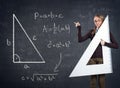 Student with a big ruler and Pythagorean theorem on blackboard
