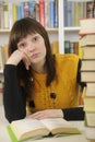 Student with books in a library Royalty Free Stock Photo