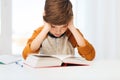 Student boy reading book or textbook at home Royalty Free Stock Photo