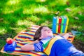 Student boy relaxing in school yard reading books