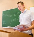 Student boy standing near the blackboard in the classroom Royalty Free Stock Photo