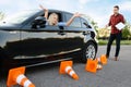 Student in car and instructor, all cones downed