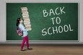 Student carries books with back to school text Royalty Free Stock Photo