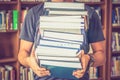Student carries books in the library Royalty Free Stock Photo
