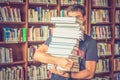 Student carries books in the library Royalty Free Stock Photo