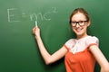 Student by chalkboard with e=mc2 Royalty Free Stock Photo