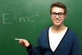 Student by chalkboard with e=mc2 Royalty Free Stock Photo