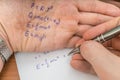 Student is cheating during exam with cheat sheet with formula Royalty Free Stock Photo