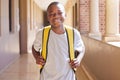 Student, child and backpack standing in school campus lobby for study. Back to school portrait, African boy and ready Royalty Free Stock Photo