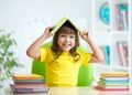 Student child with a book over her head Royalty Free Stock Photo