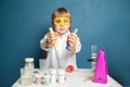 Student child looking at conical flasks in classroom Royalty Free Stock Photo