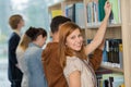 Student choosing book from bookshelf in library Royalty Free Stock Photo