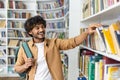 Student choosing book from library shelf for education and learning Royalty Free Stock Photo