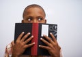 Student, classroom and hide face with book to read in front for classmates, shy and learning. Elementary school, boy and Royalty Free Stock Photo