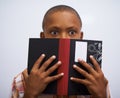 Student, classroom and hide face with book to read in front for classmates, shy and nervous. Elementary school, boy and Royalty Free Stock Photo