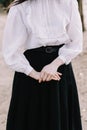 Student or college girl in uniform. Hands of the girl close-up. Girl wearing black skirt and white blouse Royalty Free Stock Photo