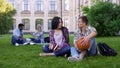 Student communicating and flirting with beautiful asian girl on college campus Royalty Free Stock Photo