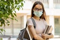 Student after covid with a backpack and a medical plaster on hand goes to school university after being vaccinated against