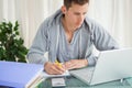 Student doing his homework with a laptop Royalty Free Stock Photo