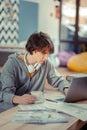 Student doing his homework using a laptop Royalty Free Stock Photo