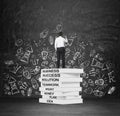 A student is drawing chalk business icons on the wall.