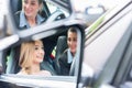 Student in driving school at the wheel of a car with her instructor