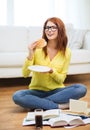 Student eating hamburger and doing homework