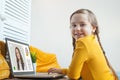 Student, education and remote learning with happy little girl in her home using a laptop. Royalty Free Stock Photo