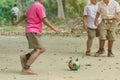 Student enjoy to play the old football with his friends on the ground Royalty Free Stock Photo