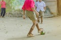 Student enjoy to play the old football with his friends on the ground Royalty Free Stock Photo