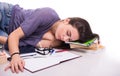 Student falling asleep on her books