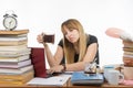 Student falls asleep with mug of coffee in hand, working in a laptop Royalty Free Stock Photo