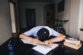 The student fell asleep doing homework at books and notebooks in his room. Teaching at home. Sleep at the table Royalty Free Stock Photo