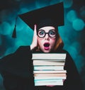 Student girl in an academic gown with books Royalty Free Stock Photo