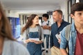 Student girl asking to professor in college corridor Royalty Free Stock Photo