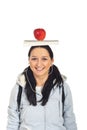 Student girl with book and apple on head Royalty Free Stock Photo