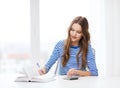 Student girl with book, calculator and notebook Royalty Free Stock Photo