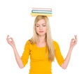 Student girl with books on head meditating Royalty Free Stock Photo