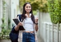 Student, girl and fist pump on campus with smile, headphones and books for learning, development and study. Female Royalty Free Stock Photo