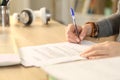 Student girl hands signing contract at home Royalty Free Stock Photo