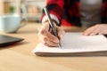 Student girl hands writing notes on notebook at home Royalty Free Stock Photo