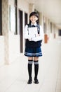 student girl holding books in front of classroom Royalty Free Stock Photo