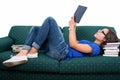 Student girl laid on couch reading from notebook