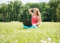 Student girl with laptop outdoors. College or university student young woman in summer park smiling happy. Royalty Free Stock Photo