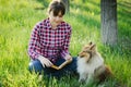 Student girl learning in nature with dog Royalty Free Stock Photo