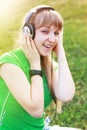 Student girl outside in park listening Royalty Free Stock Photo