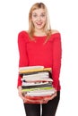 Student girl with a pile of heavy books Royalty Free Stock Photo