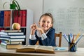 student girl politely listens to the teacher during the lesson in the classroom. Royalty Free Stock Photo