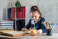 student girl politely listens to the teacher during the lesson in the classroom. Royalty Free Stock Photo