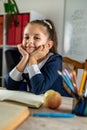 student girl politely listens to the teacher during the lesson in the classroom. Royalty Free Stock Photo